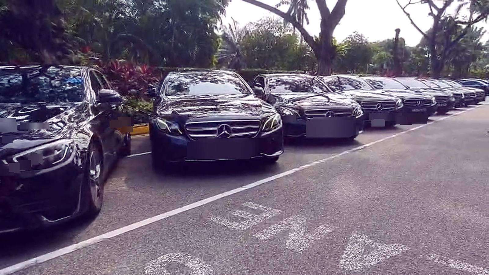 Executive sedans lined up for delegates at a Singapore conference venue